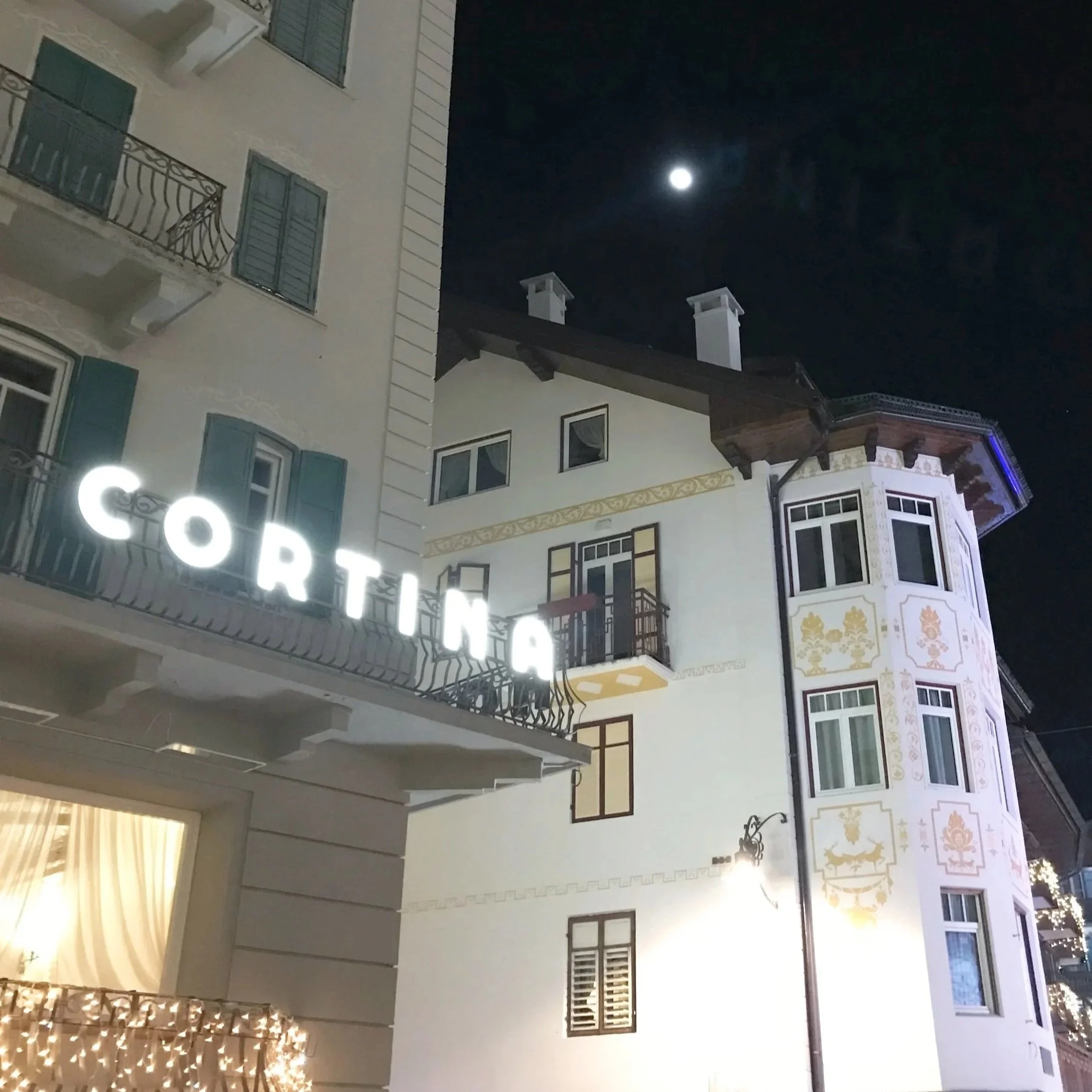 An illuminated sign reading "Cortina" in the Italian ski town of Cortina d'Ampezzo.