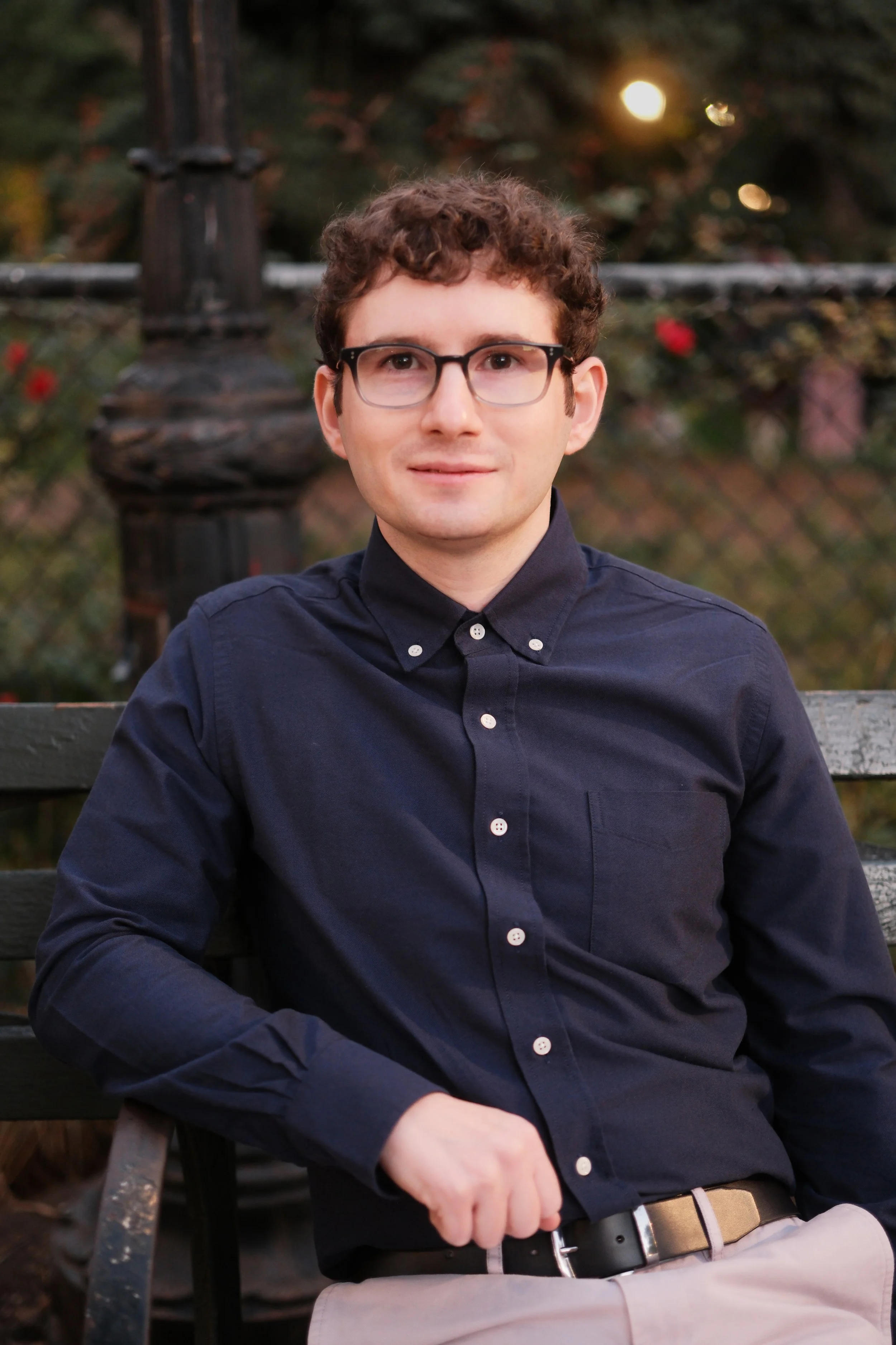 Josh Arnon sitting on a bench in Tompkins Square Park.