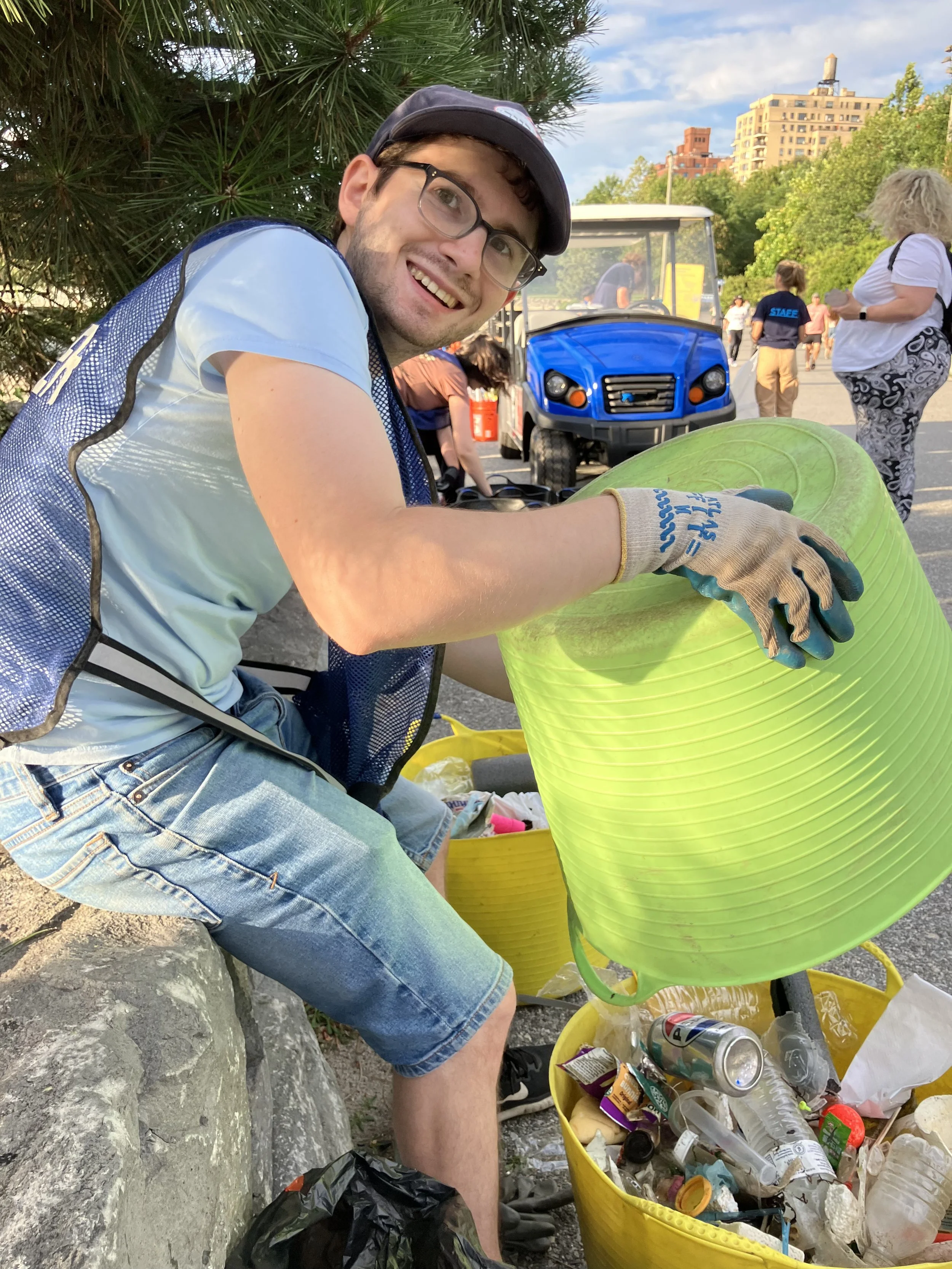Josh Arnon cleaning shorelines from debris as part of Brooklyn Bridge Park’s Coastal Cleanup program.