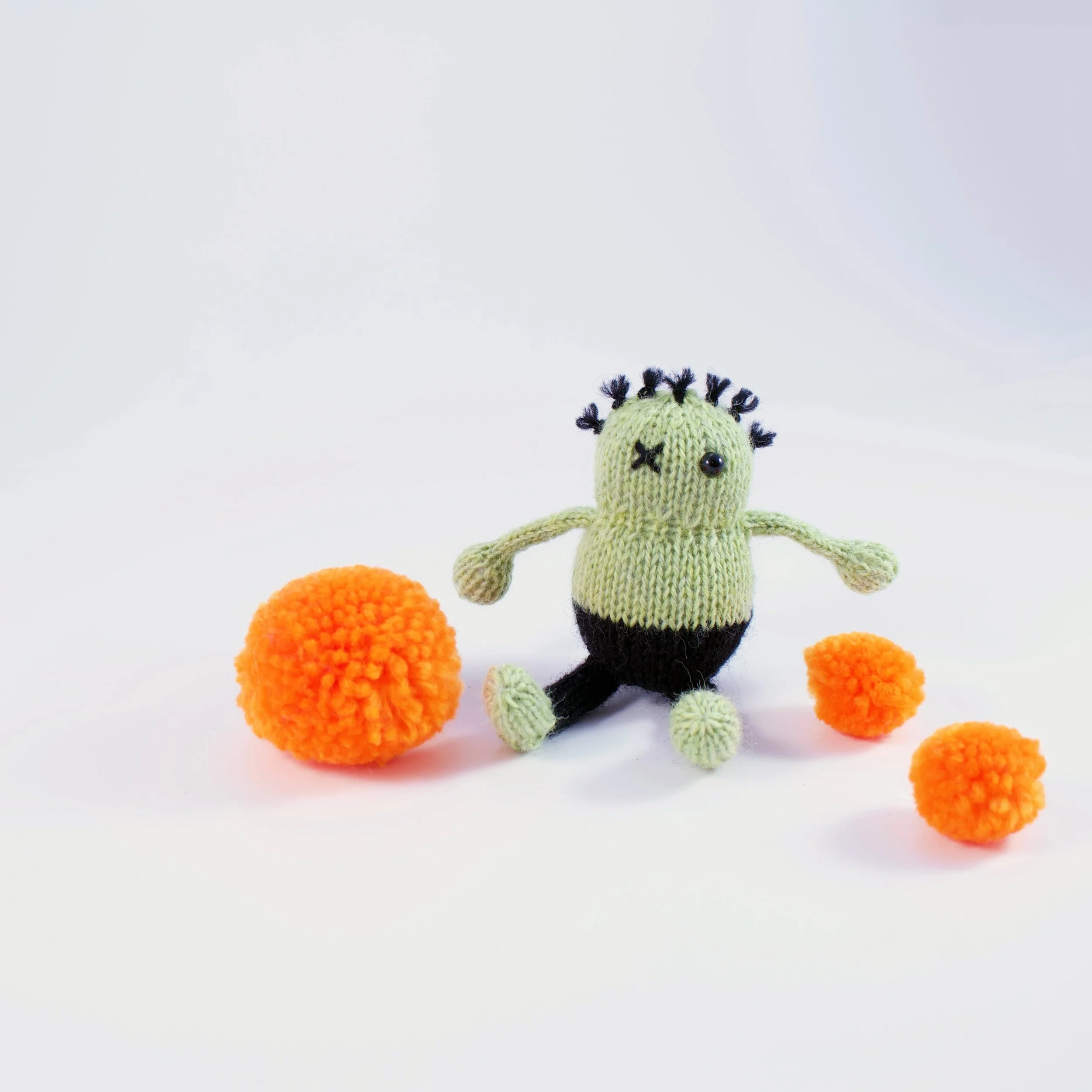 KnittedPocketZombieWithPomPoms.jpg