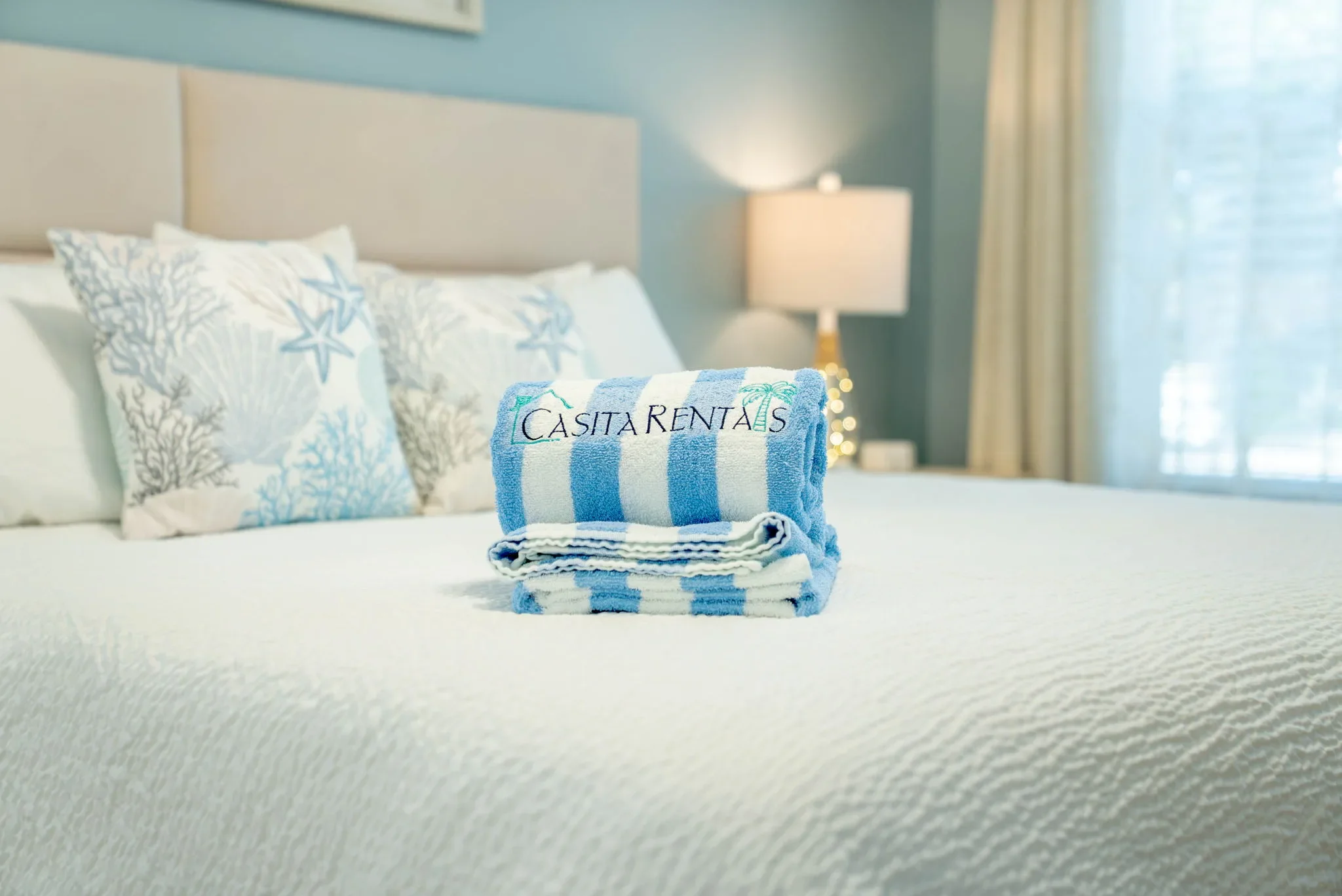 Folded Casita Rentals branded towel on the bed at The Oasis vacation rental