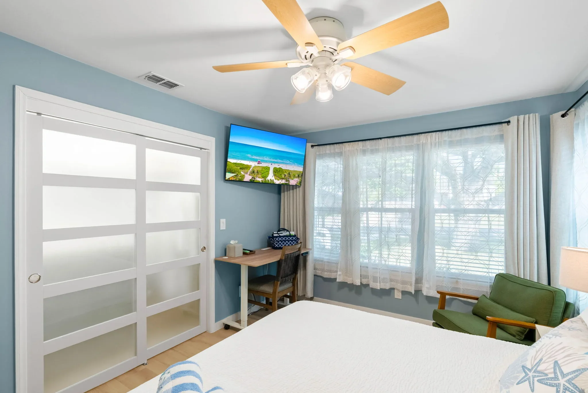 Primary king bedroom with window and closet doors at The Oasis Corpus Christi