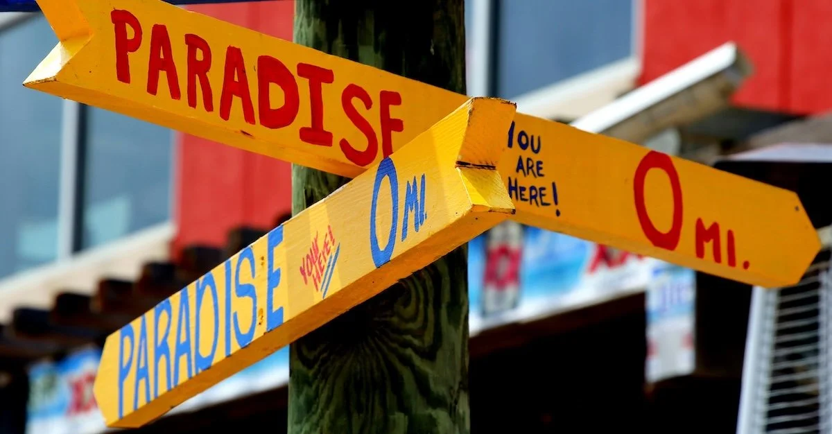 Paradise directional signs on the beach.