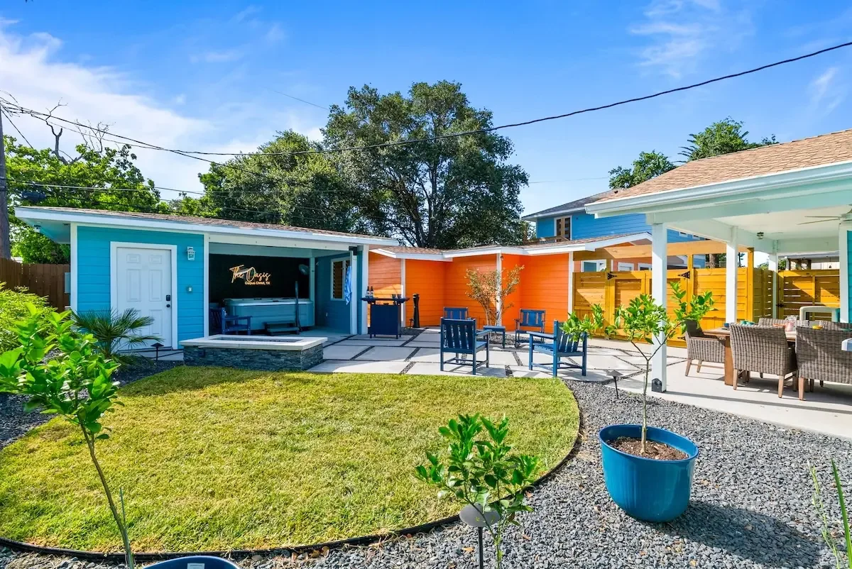 Wide backyard courtyard view of the teal and orange casitas in Corpus Christi