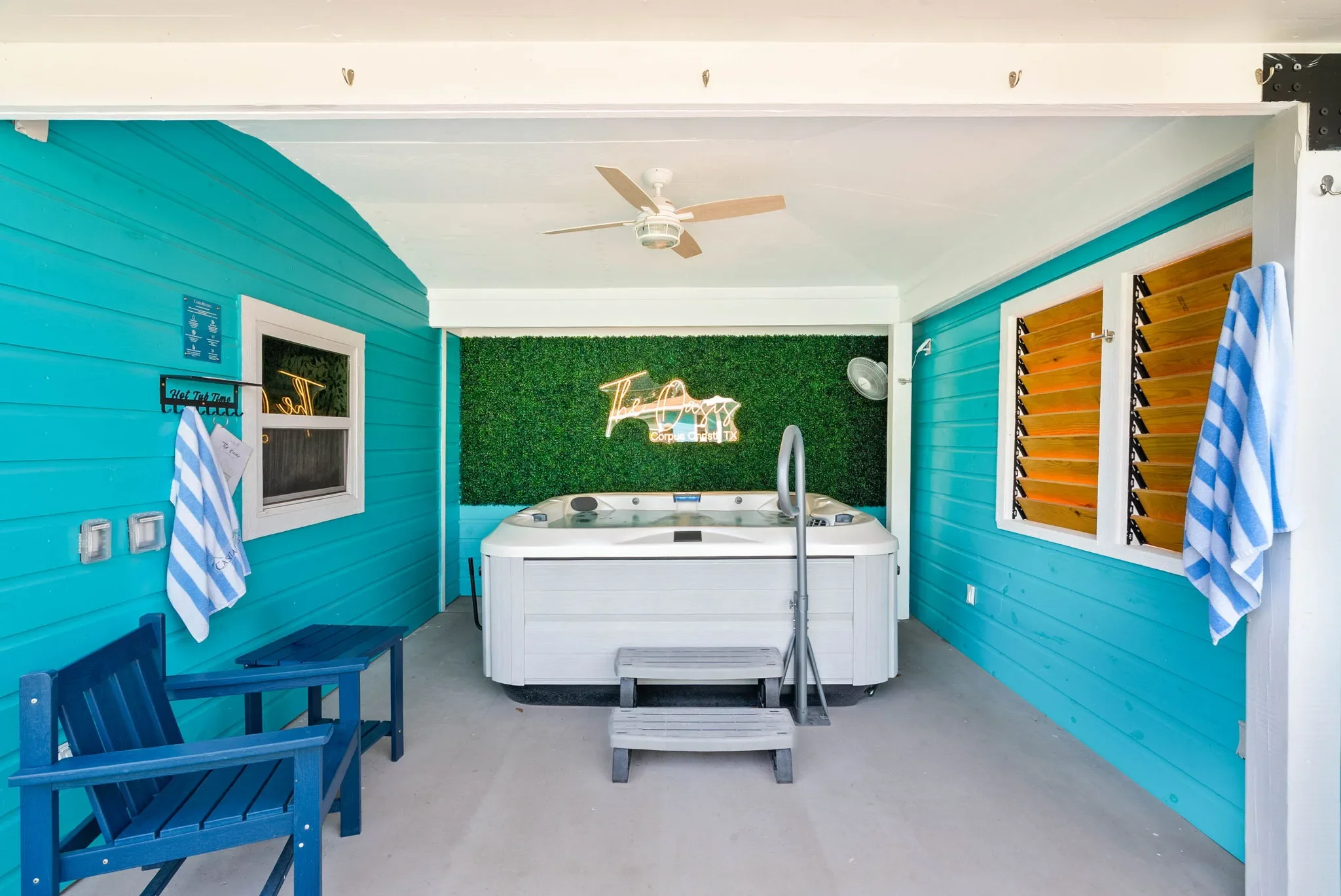 Covered hot tub room with shutters and bench seating at The Oasis