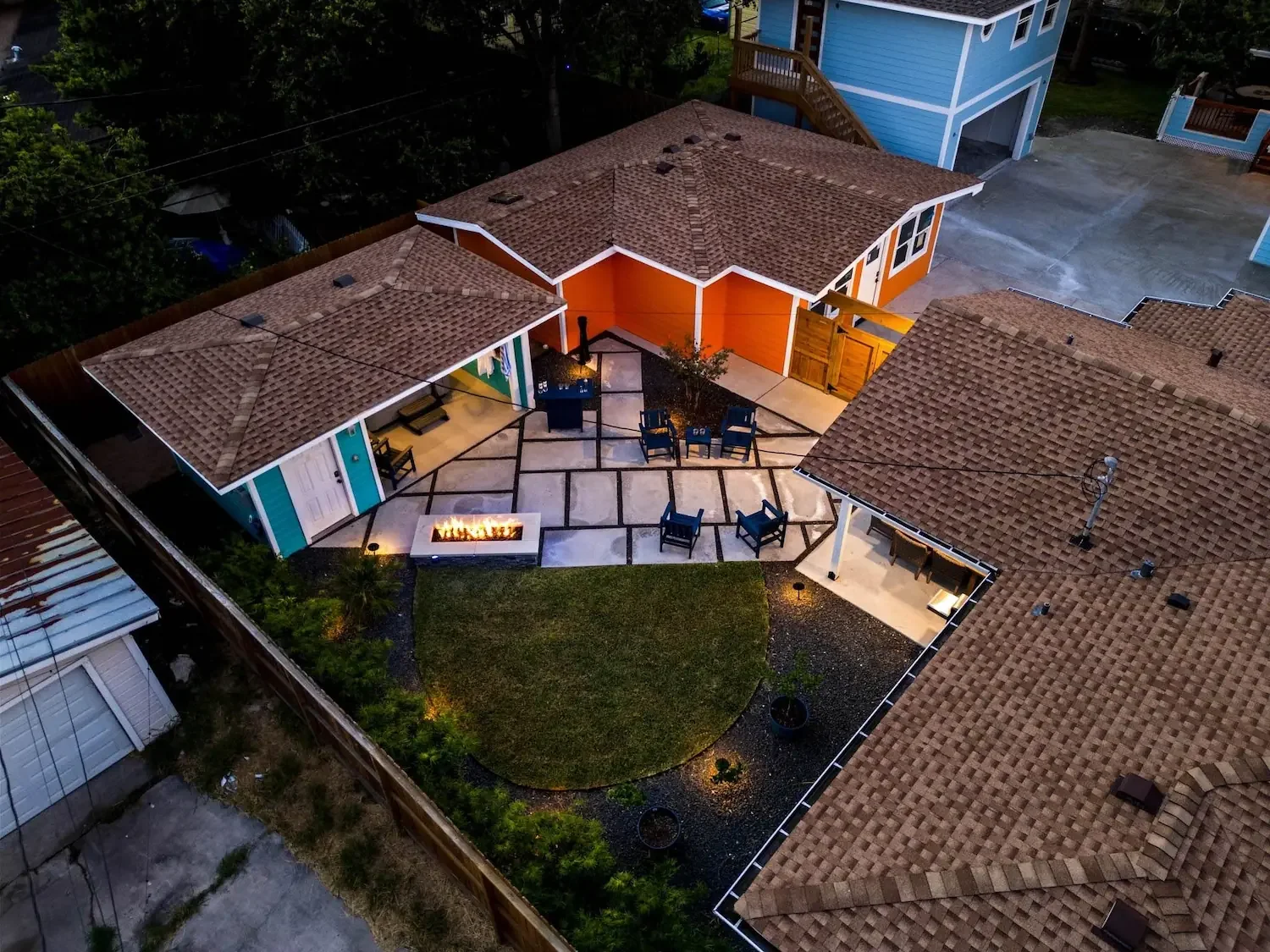 Aerial drone view of the lit backyard at twilight at The Oasis vacation rental