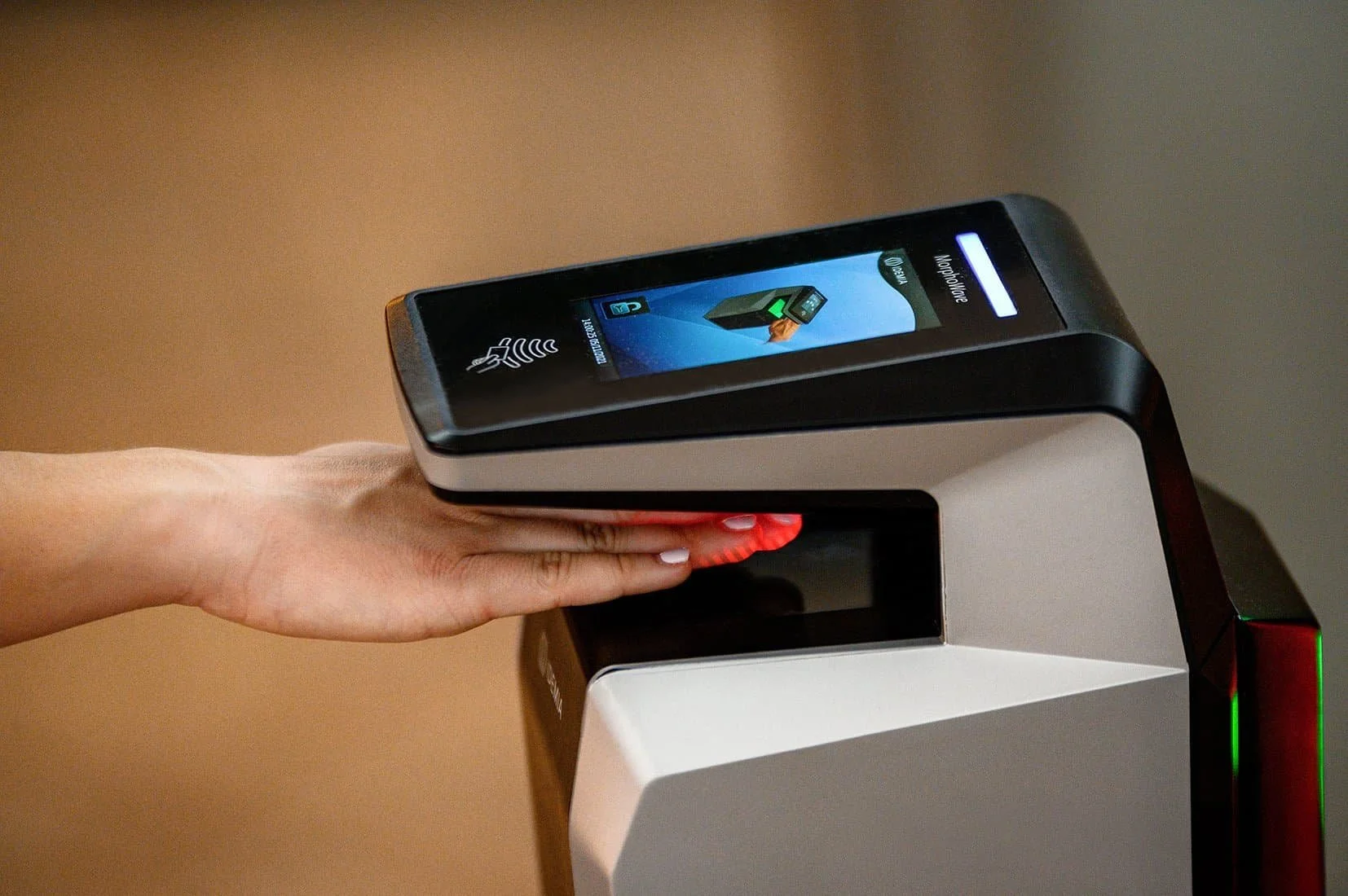 Person scanning their hand at a contactless payment terminal with a smartphone for payment.