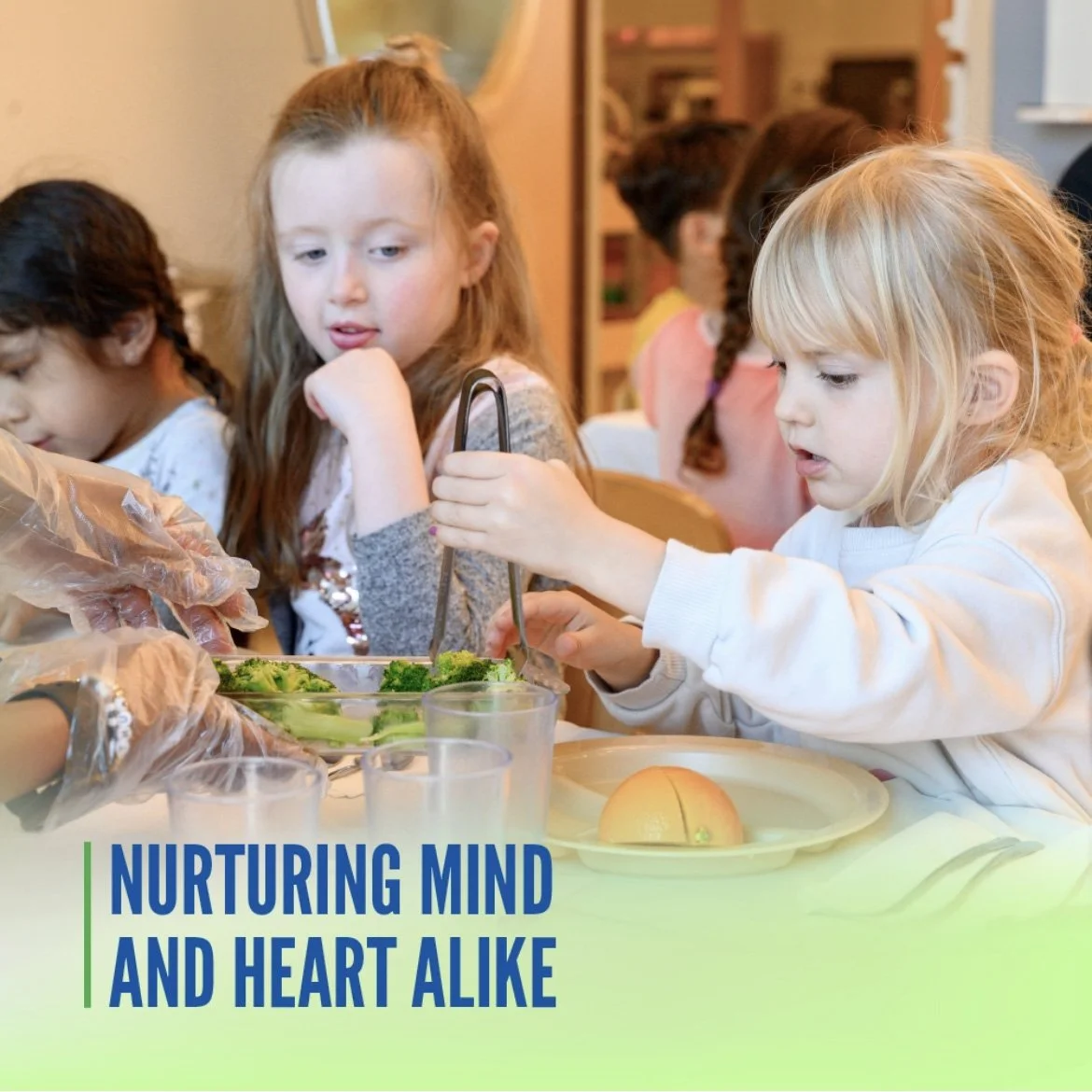 Children sitting at a table engaging in an activity, with a focus on two girls handling food ingredients, with a green and blue text overlay that reads 'Nurturing Mind and Heart Alike'.