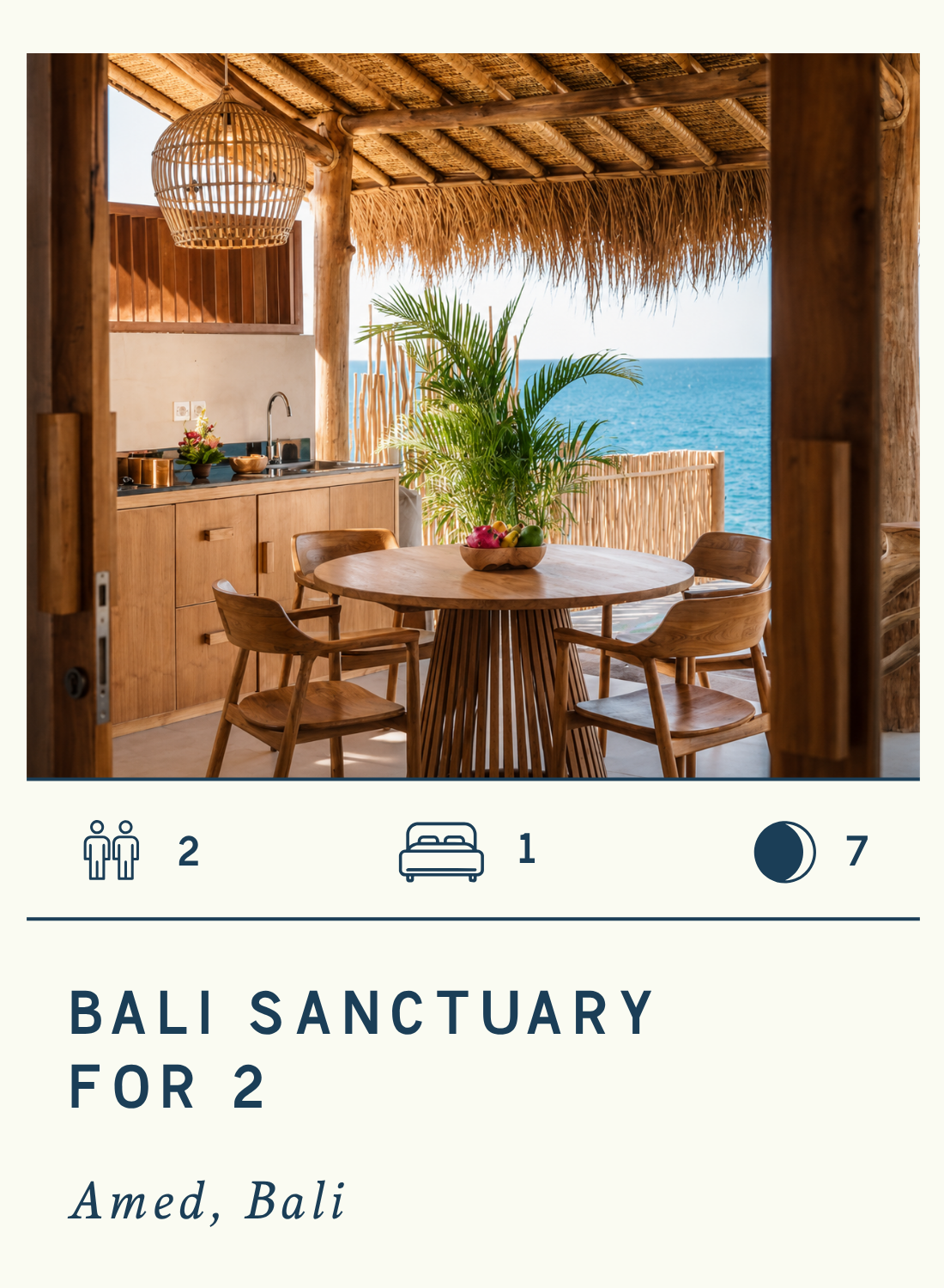 A balcony with a rustic wooden dining table and four chairs, overlooking the ocean, with tropical plants and thatched roof, part of a Bali sanctuary for two.