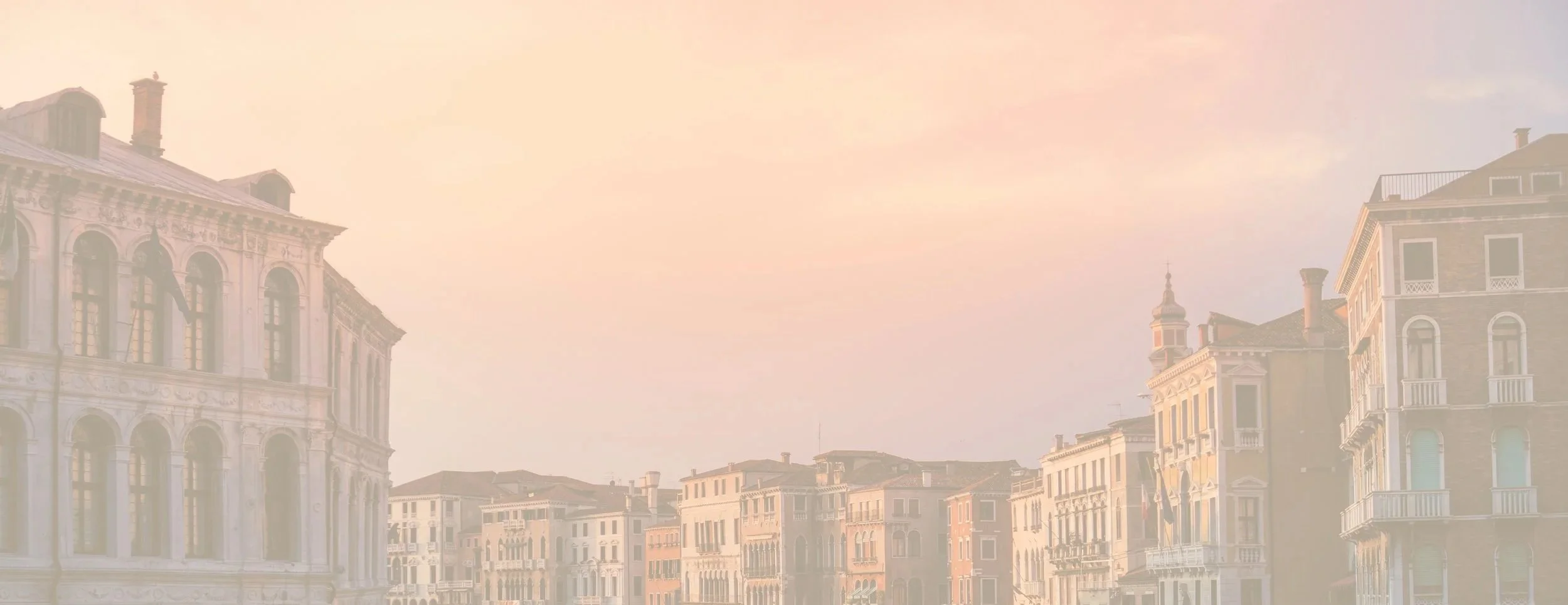 Sunset over historic European-style buildings with ornate facades in Venice, Italy.