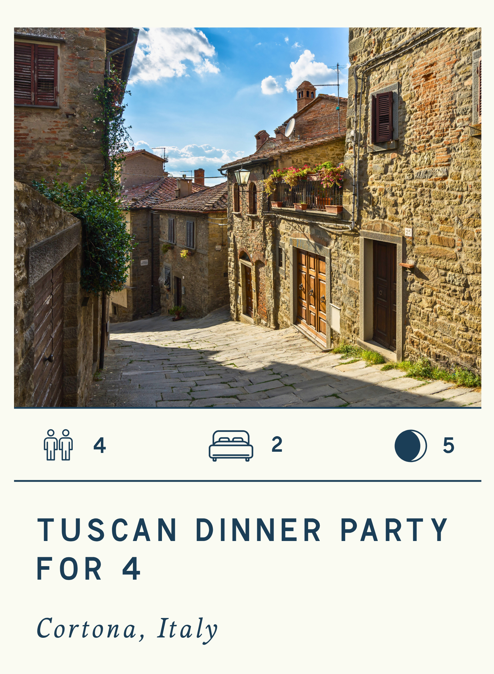 A narrow, cobblestone street in a small Italian village with stone buildings, flower pots, and a bright blue sky with clouds.
