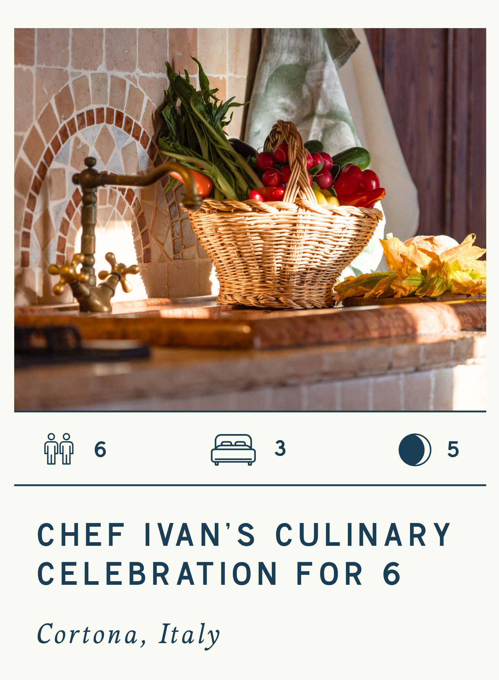Basket of fresh vegetables on a kitchen countertop with a rustic tile backsplash, next to a yellow flower and a green cloth.