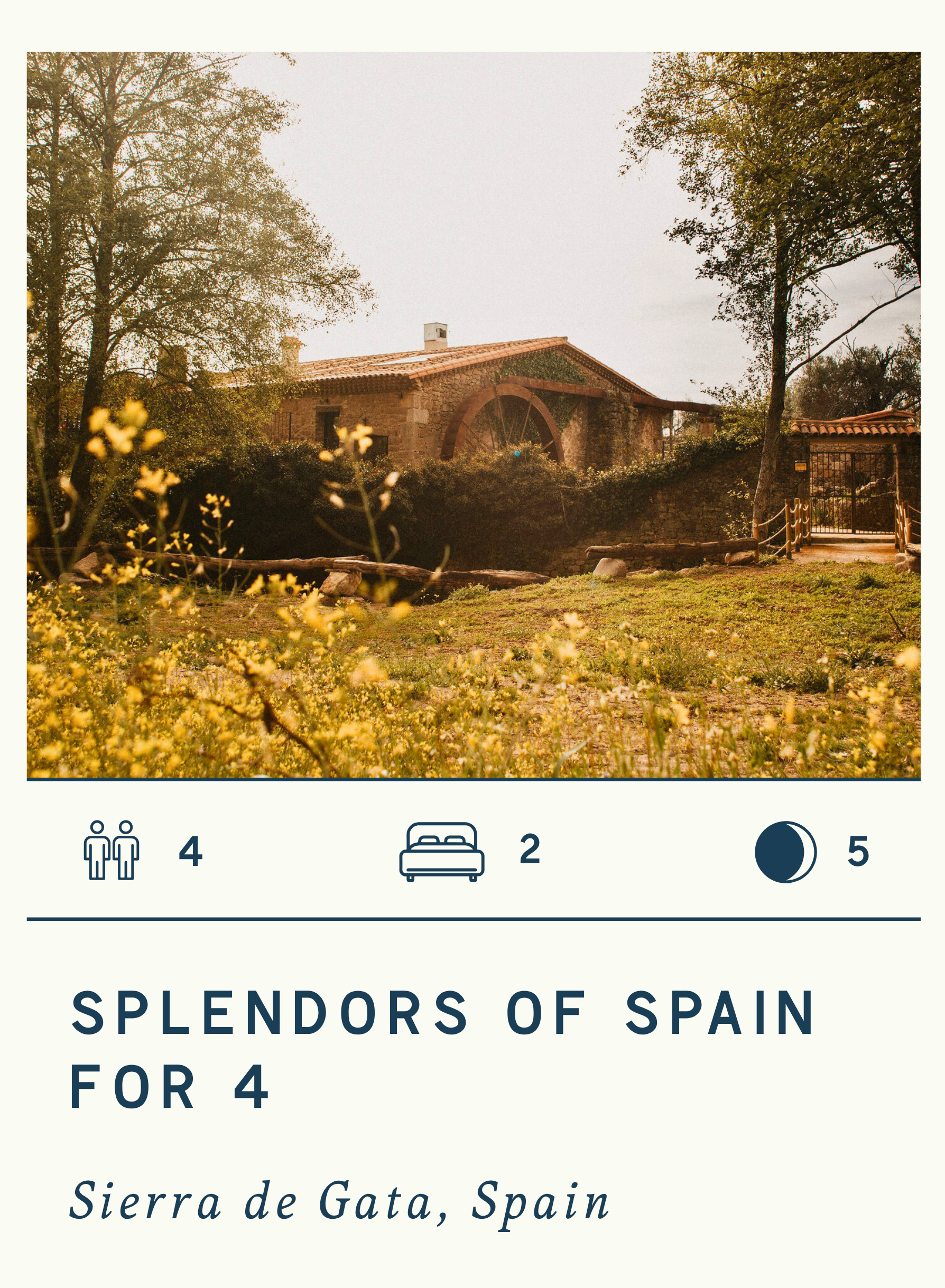 A scenic view of a rustic stone house surrounded by trees and grassy landscape in Sierra de Gata, Spain, with a cloudy sky overhead.