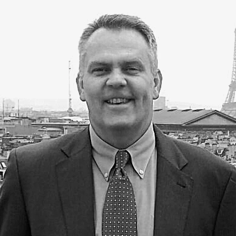 Black and white portrait of David Sullivan smiling.