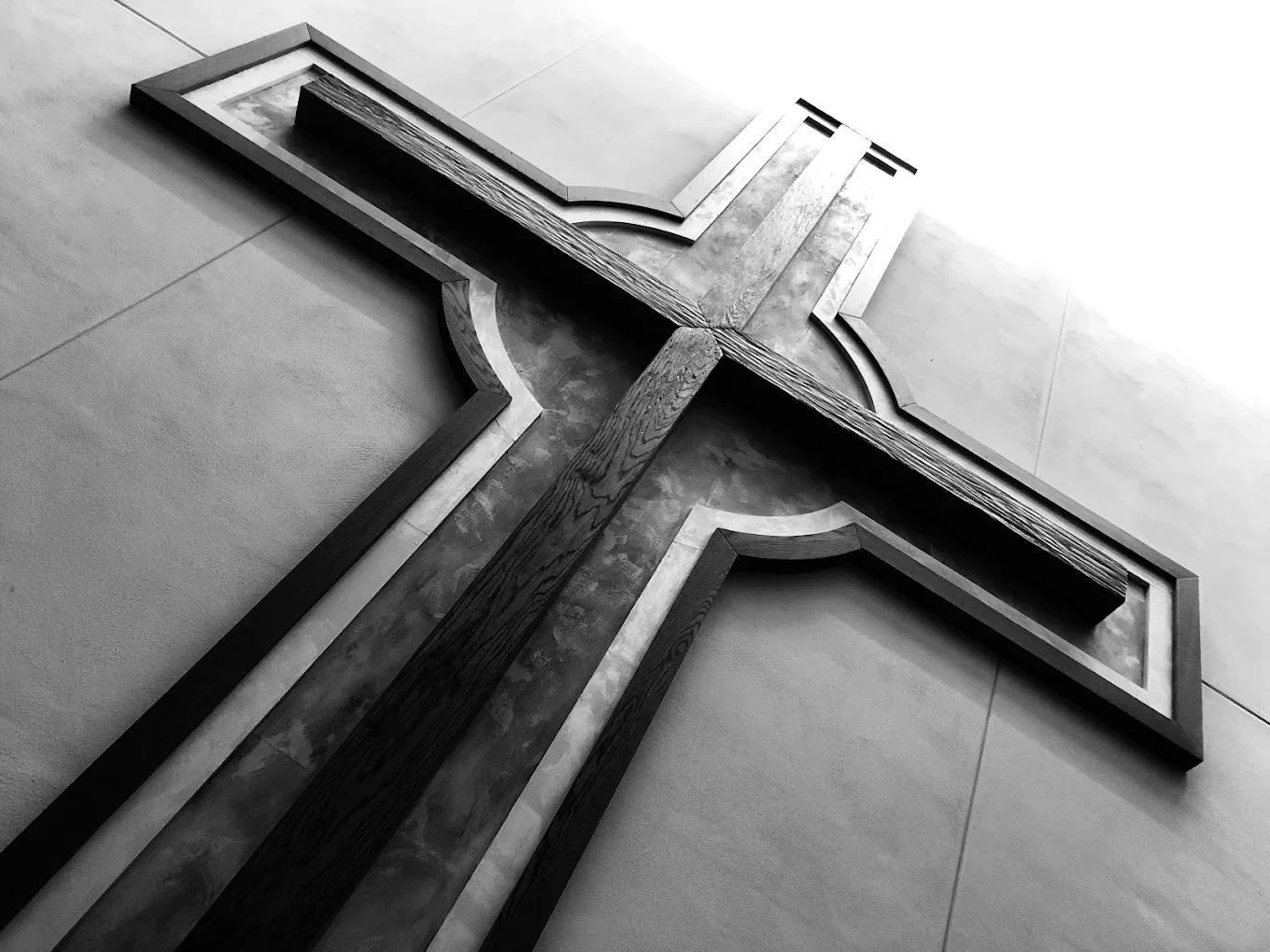 An illustration of a hand holding a red heart with an American flag background.