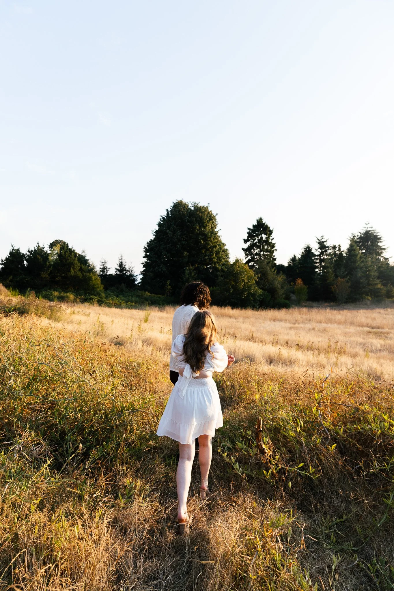 Couple during sunset engagement session at Discovery Park in Seattle