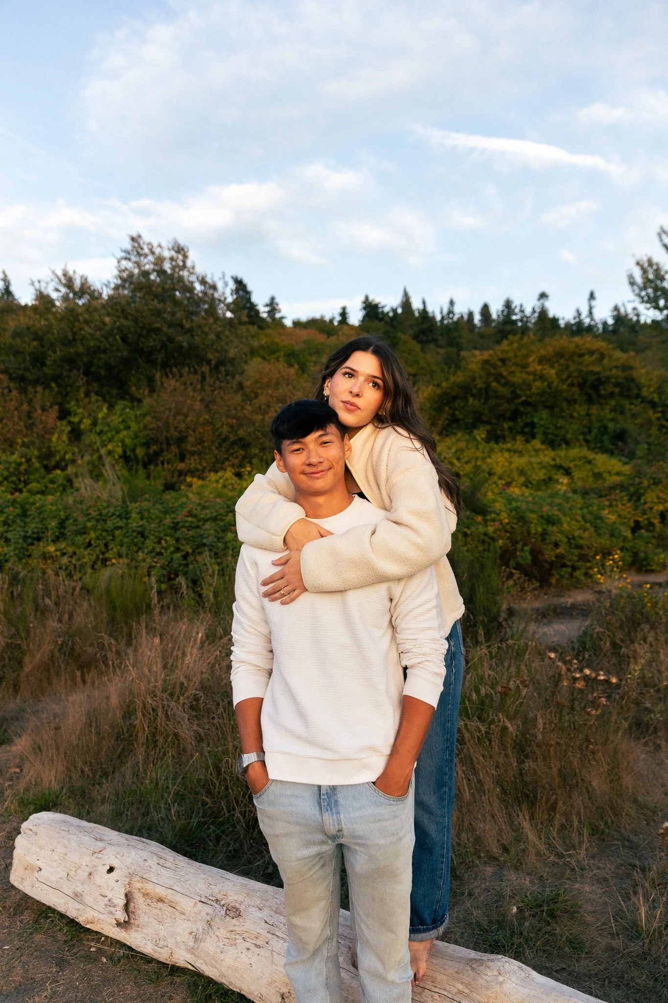Couple during sunset engagement session at Golden Gardens Park in Seattle