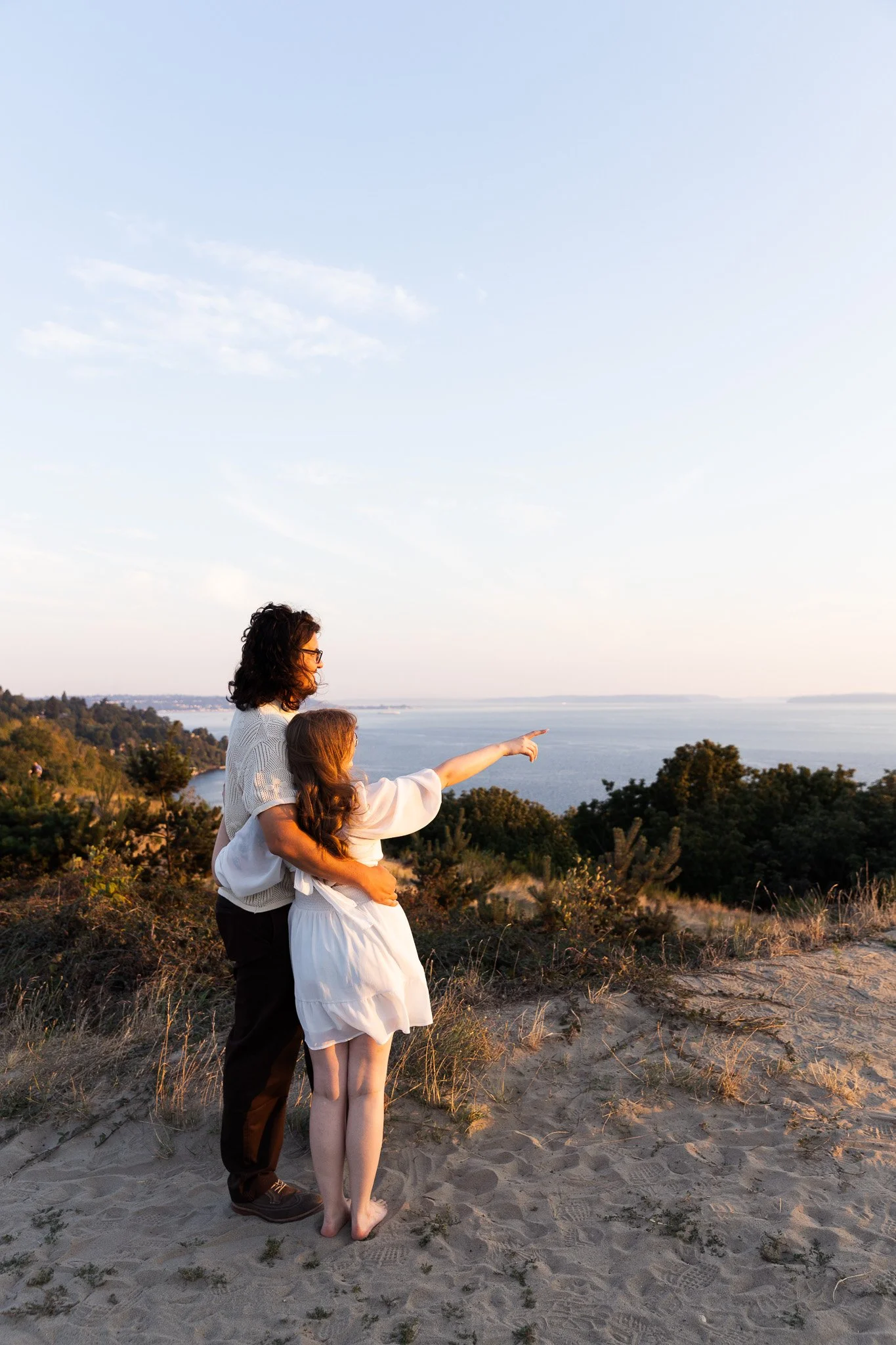 Couple during sunset engagement session at Discovery Park in Seattle