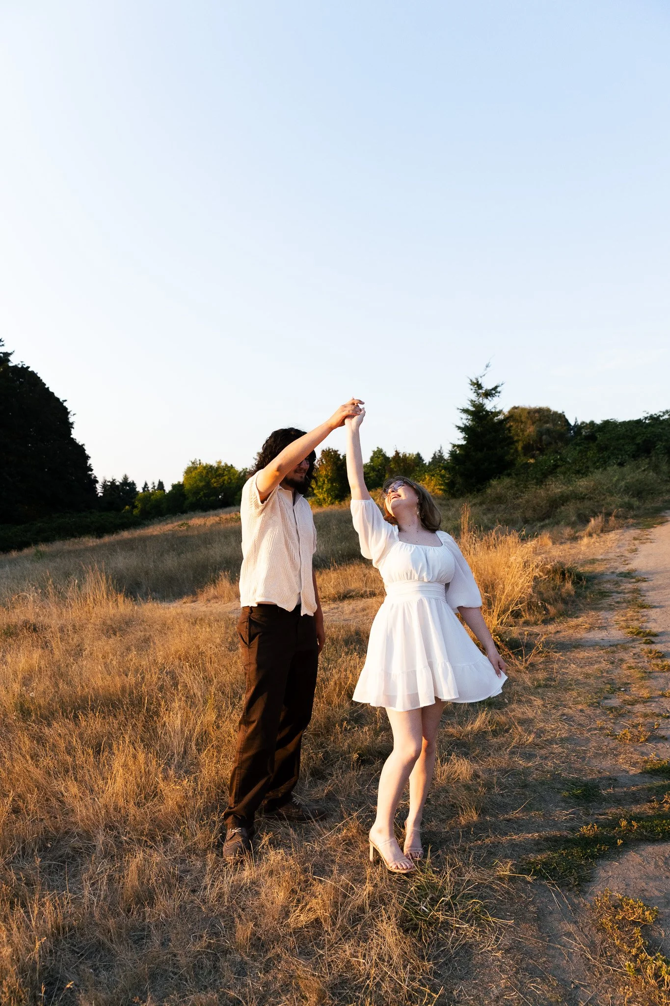 Couple during sunset engagement session at Discovery Park in Seattle