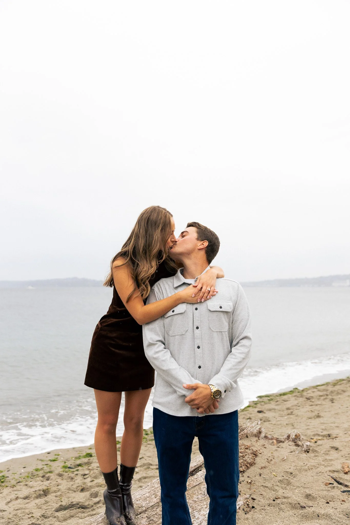 couple during engagement shoot in alki beach west seattle