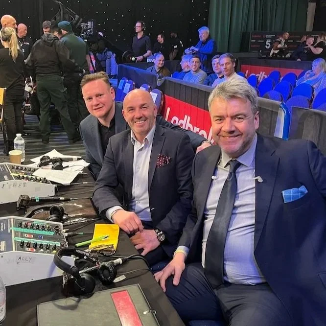 Dave Farrar commentating at a sporting event with World Boxing Champions George Groves and Barry Jones, who left him positive reviews, calling him "one of the best in the business and a joy to work with."
