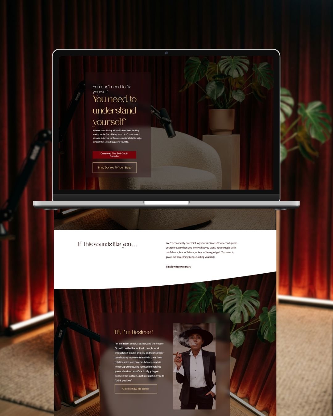 A laptop screen displaying a website about self-understanding and coaching, with a background of red stage curtains, a potted plant, and a beige lounge chair. The website features headings, buttons, and an introduction to a coach named Desiree.