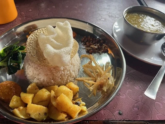 Plate with dal bhat next at a Nepal teahouse.