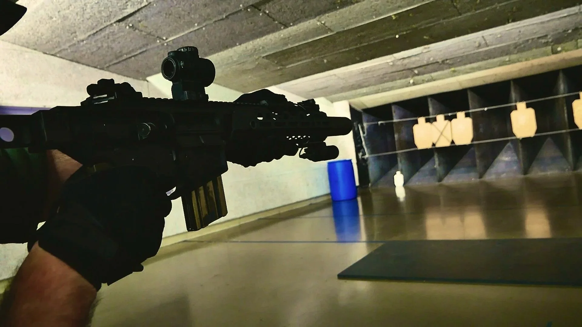 Close-up of a green and black tiger stripe rifle sling that reads 'EDGAR SHERMAN DESIGN'; the sling is wrapped around a surefire d60 ar15 magazine.
