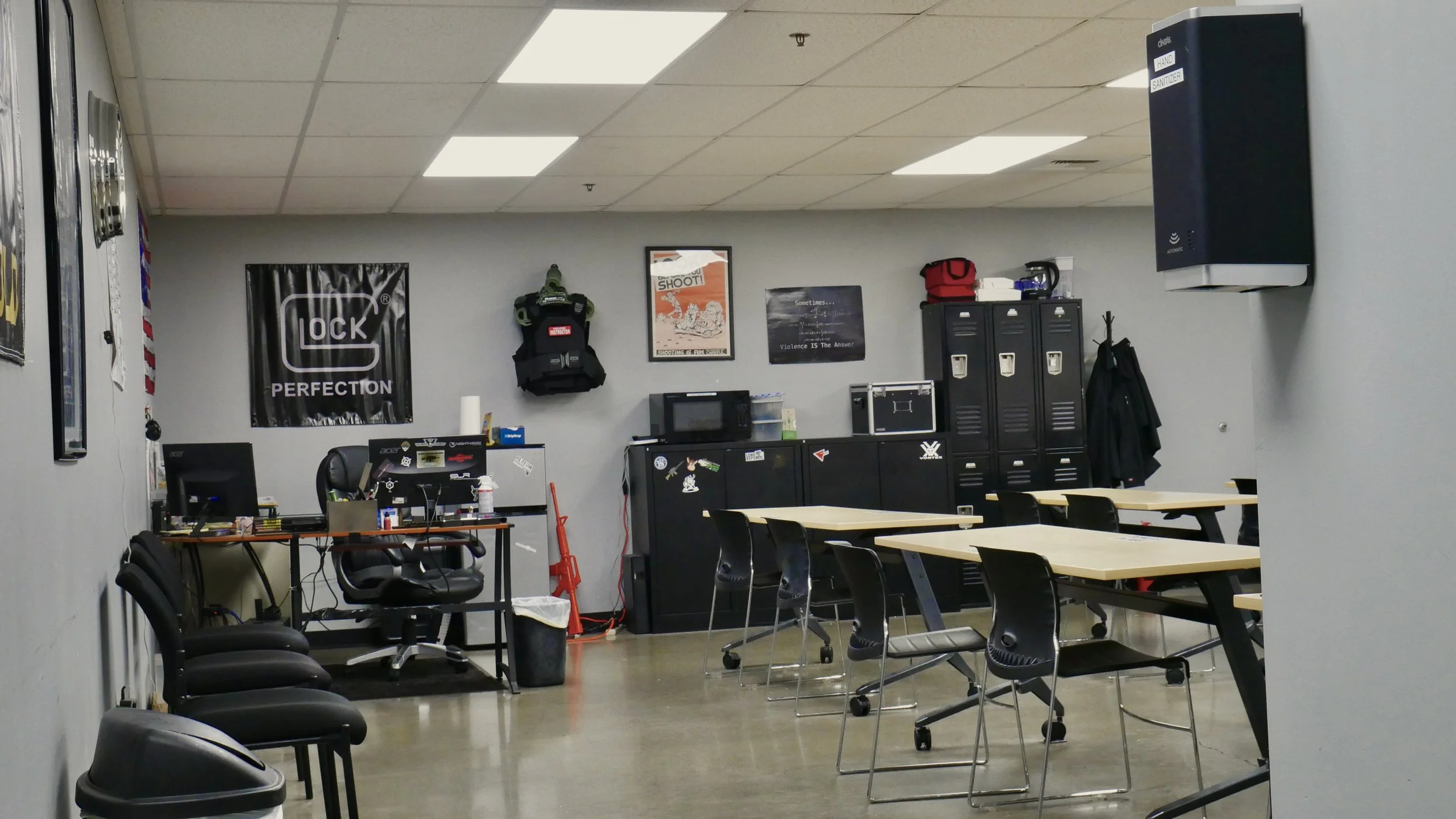 a desk and instructor corner of a shooting range classroom.