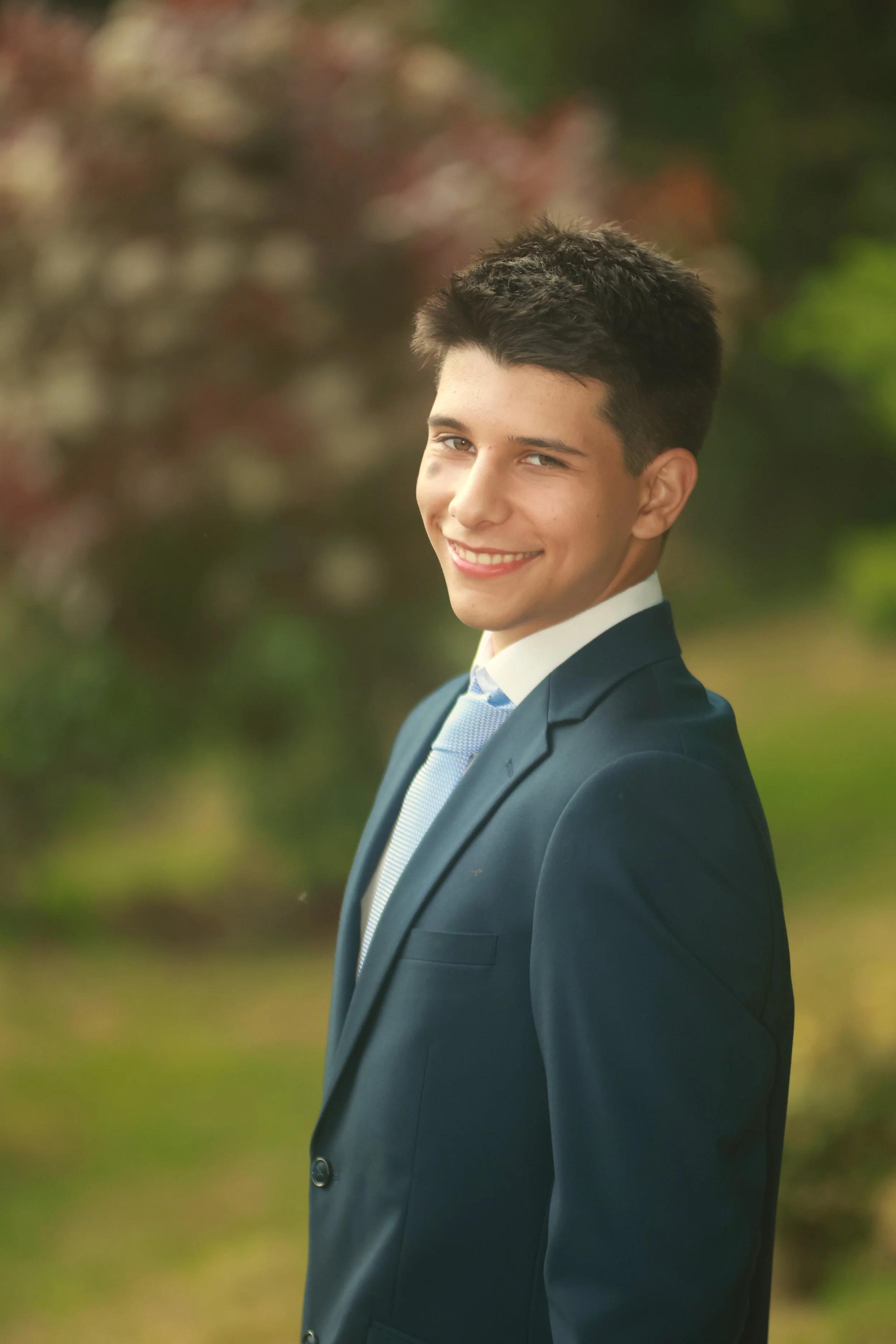 A male graduate wearing a suit