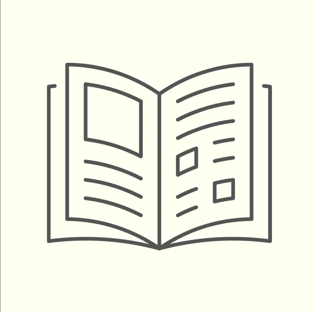 Line drawing of an open magazine or catalog with text lines and shape placeholders.