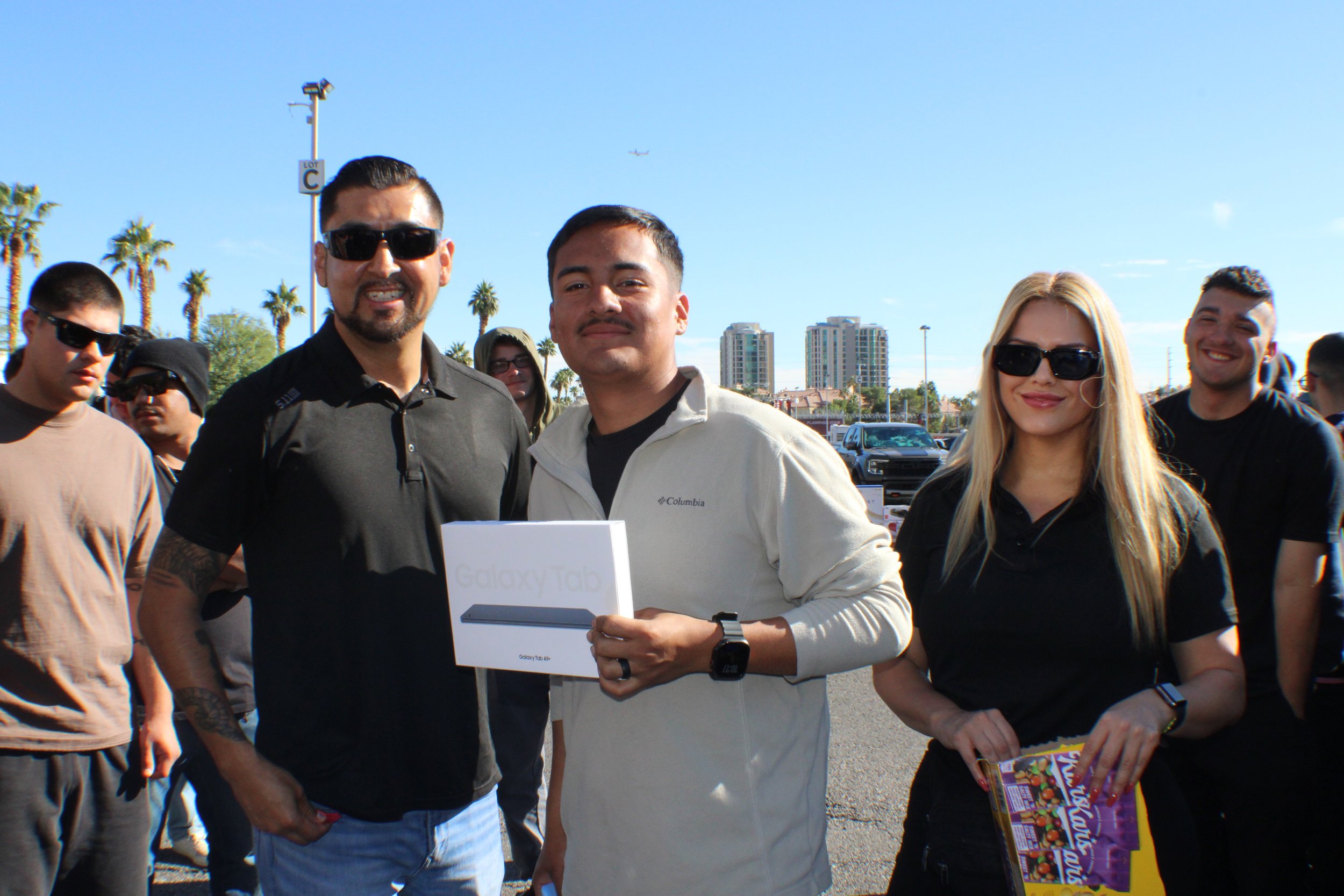 American flag waving in the wind against a partly cloudy sky.