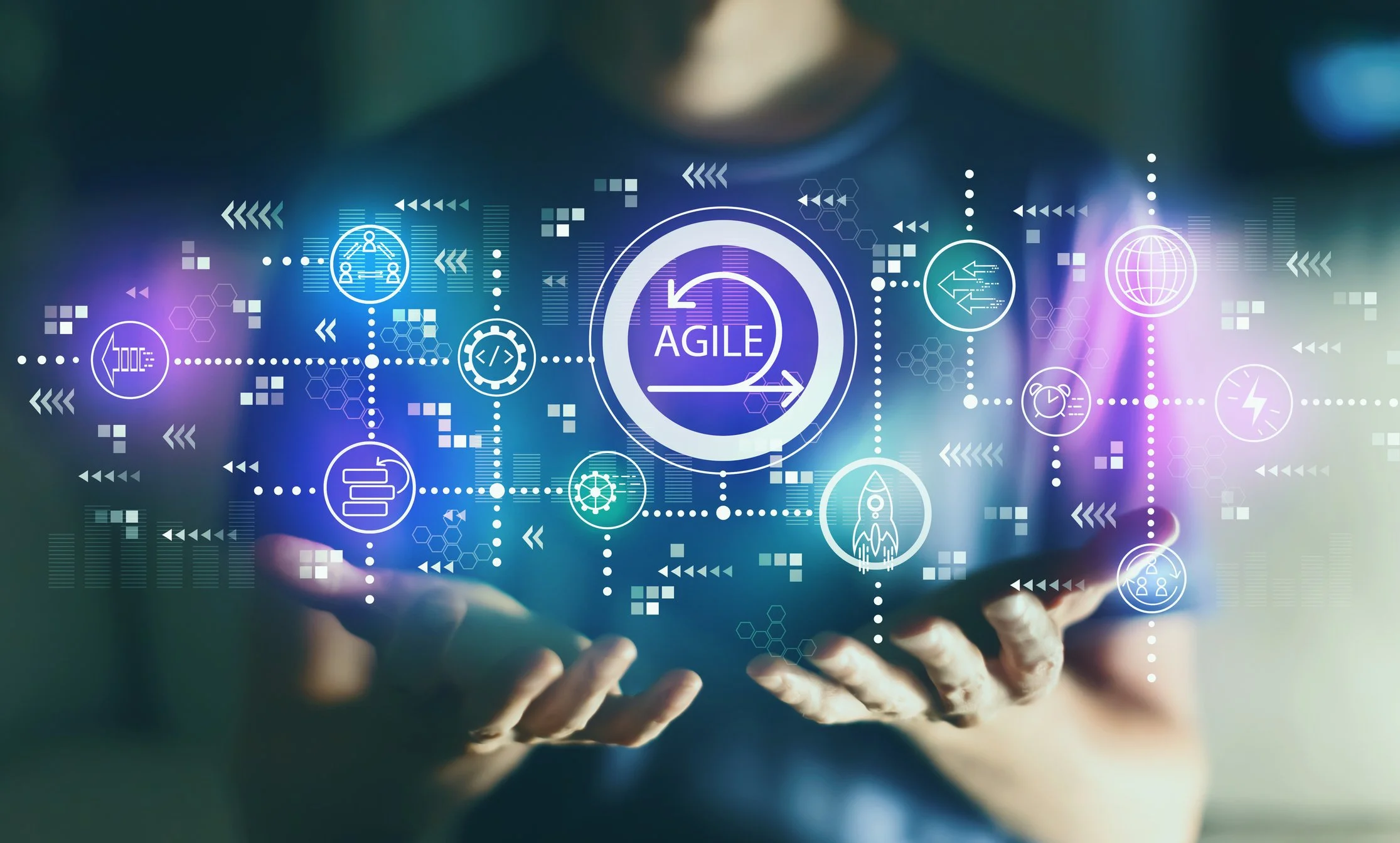 Person holding a tablet with holographic digital icons related to agility, technology, and innovation floating above the screen, including a central icon labeled 'Agile'.