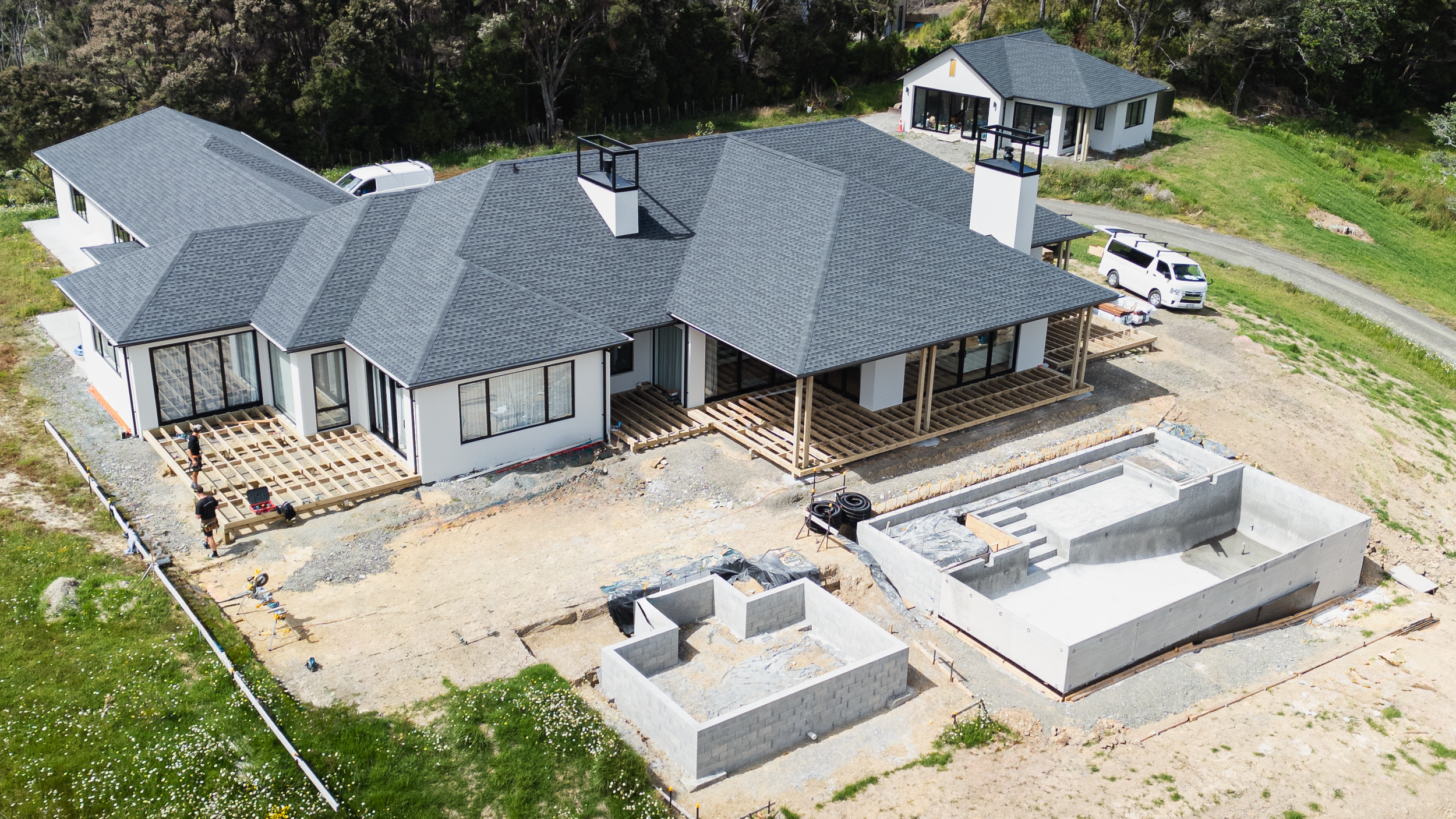 Stanmore Bay outdoor renovation: wrap-around deck with pool & hot tub underway, offering stunning ocean views.