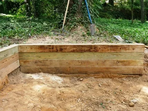 High-quality retaining wall installed in an Auckland backyard – custom retaining walls by expert builders.