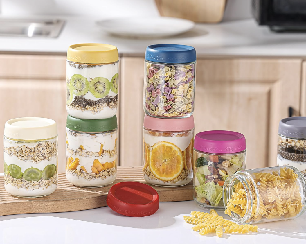 Colorful glass jars filled with easy overnight oats meal prep topped with fruit, oats, and yogurt for a quick healthy breakfast