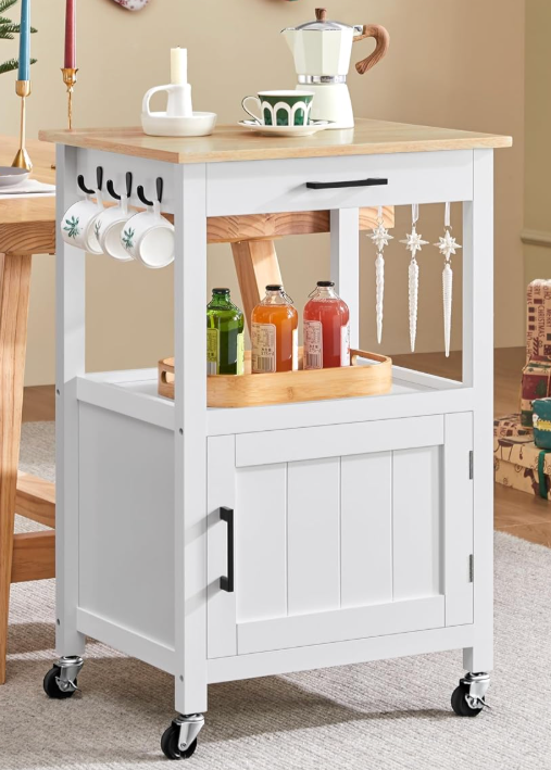 Small rolling kitchen cart with storage shelves, hooks for mugs, and a wooden top used as a meal prep station in an affordable, space-saving kitchen setup