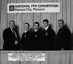 Five men standing in front of a sign at the National FFA Convention in Kansas City, Missouri.