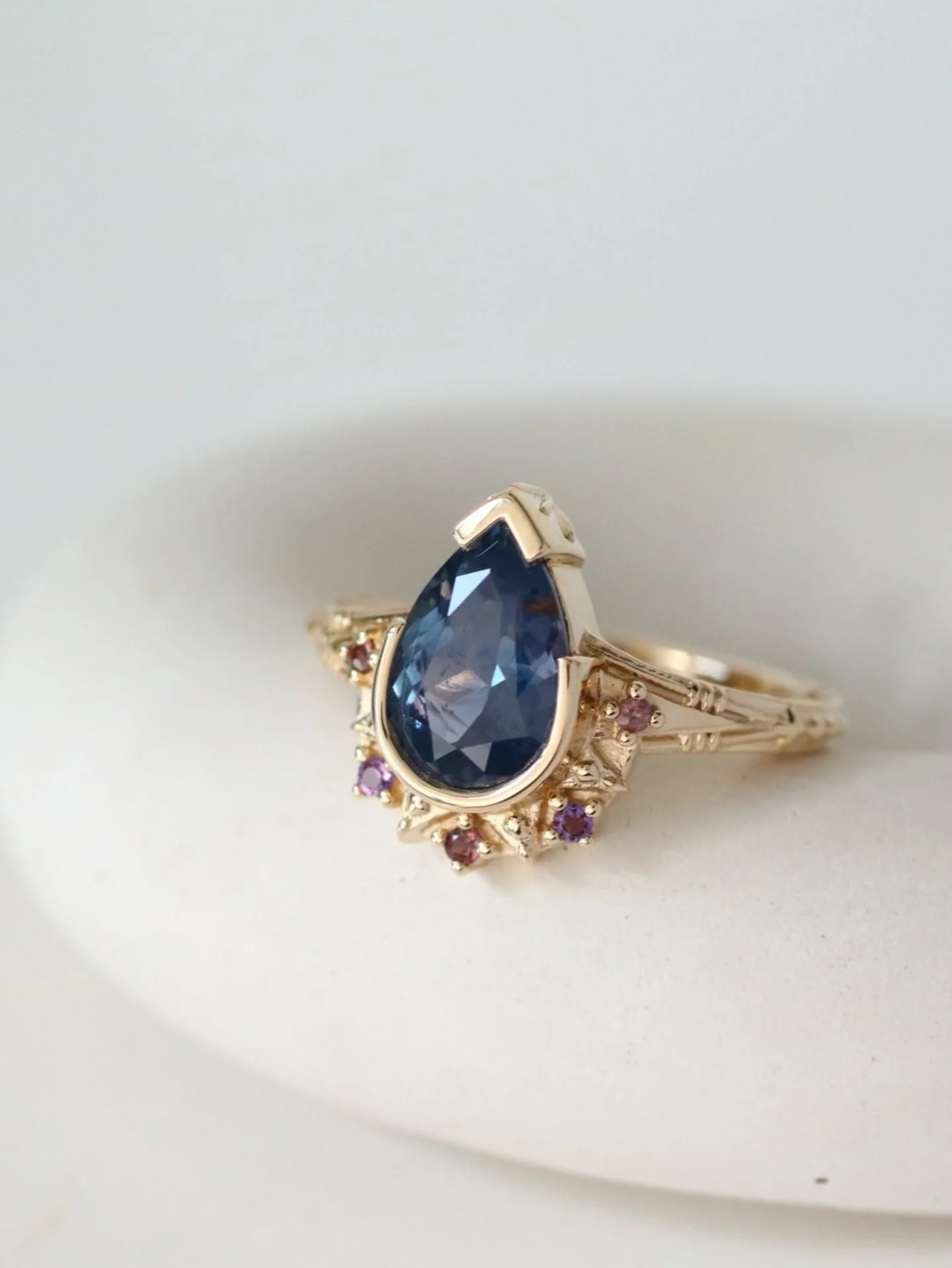 The most stellar, spectacular, stunning engagement ring for J.J.! It features the most cosmic color changing natural pear sapphire center stone and accented by amethysts and sapphires in colors reminiscent of outer space.

One of J.J.&rsquo;s design 