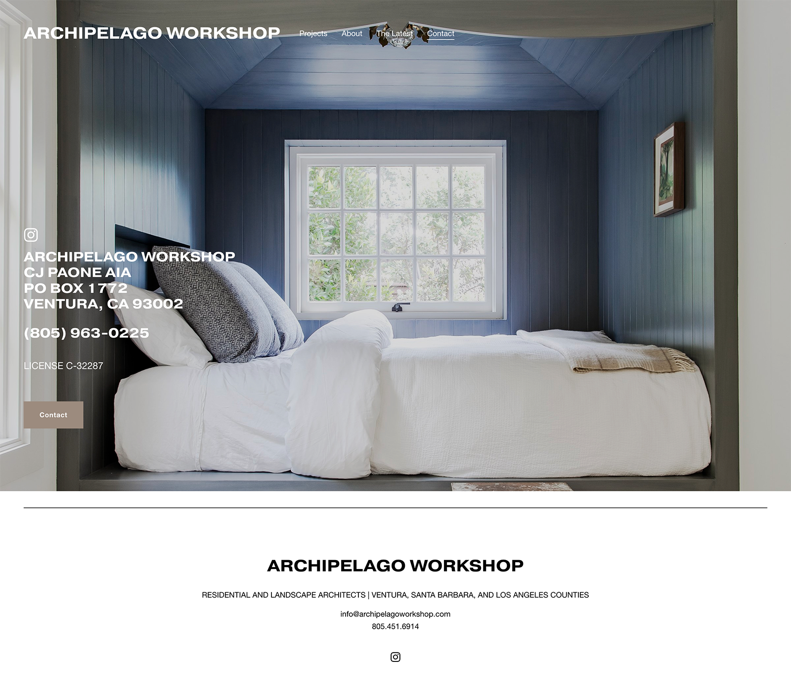 Interior of a bedroom with dark blue paneled walls, a white bed with multiple pillows, a window with greenery outside, a small framed picture on the wall, and a ceiling fan with a light fixture.