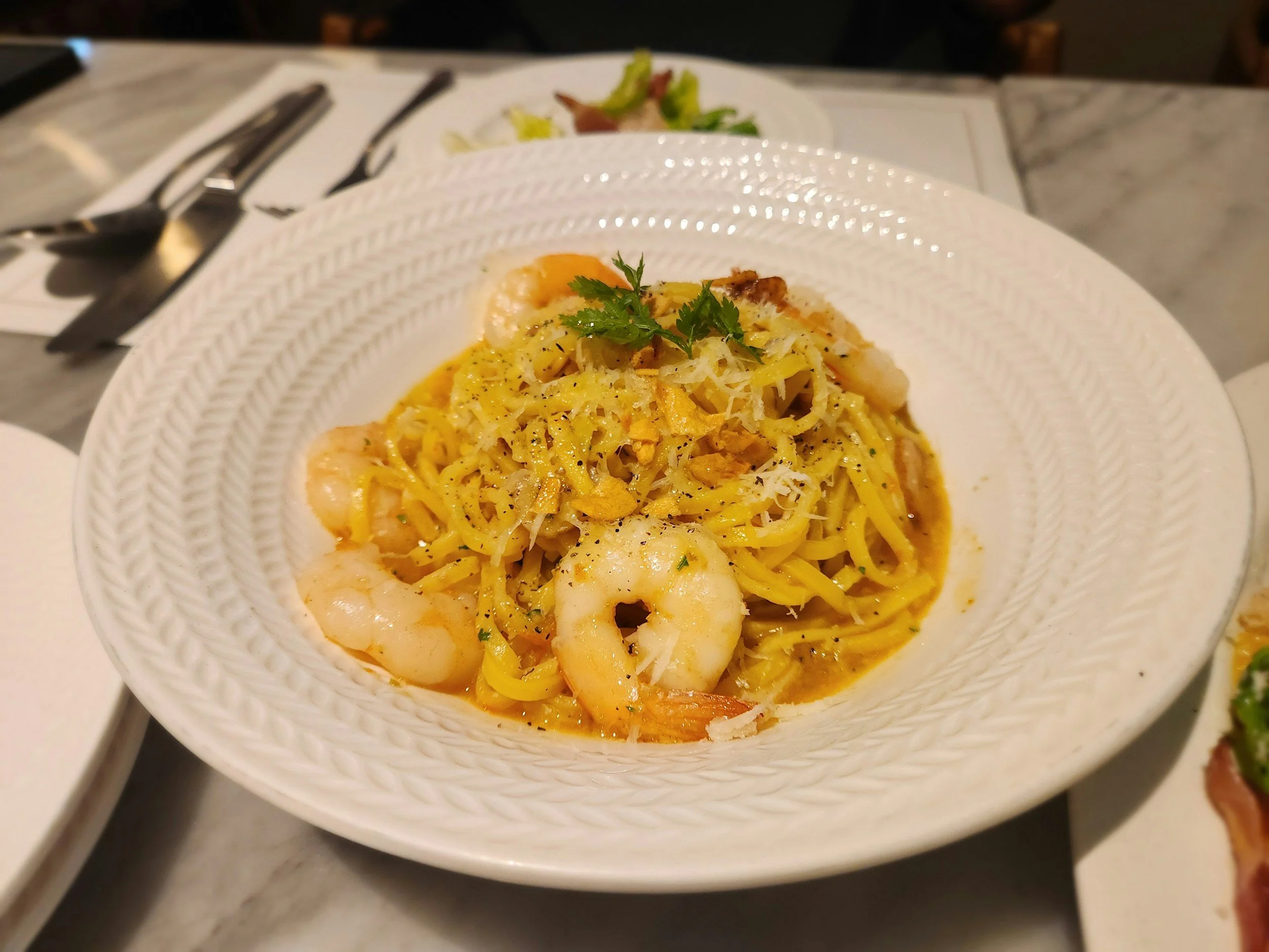 Plate of shrimp fettuccine pasta garnished with parsley