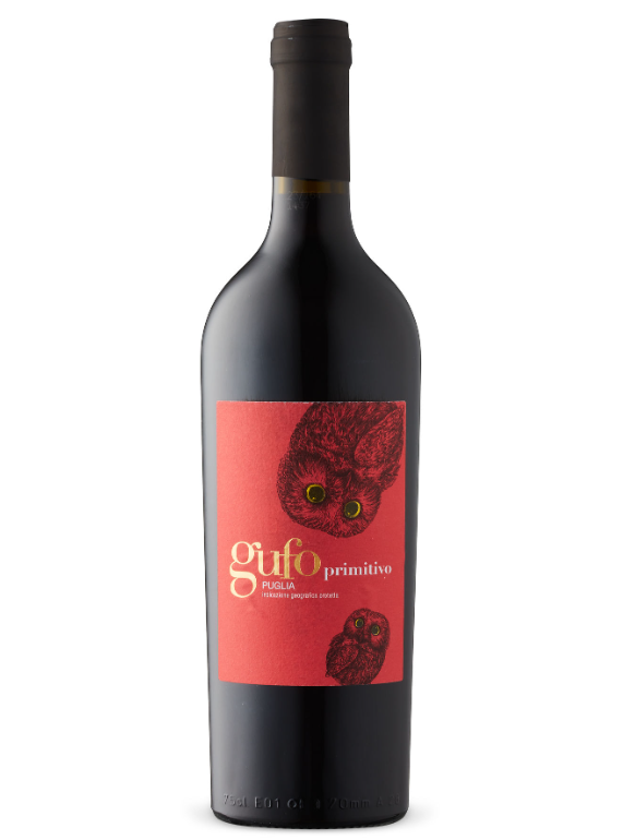 A black wine bottle with a red label featuring an illustration of an owl and a kitten, and the text "Gufo Primitivo Puglia".