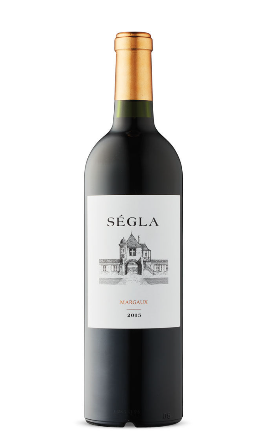 A dark glass wine bottle with a white label featuring a sketch of a chateau and text reading 'Ségla', 'Margaux', and '2015', topped with a gold capsule.