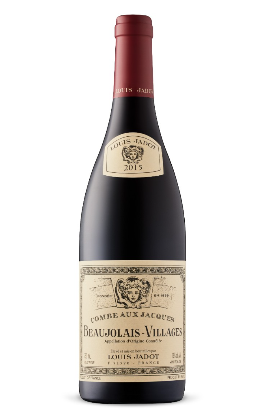 A bottle of Louis Jadot Beaujolais-Villages red wine from 2015, with a red foil top and a beige label featuring a woman's face and text in French.