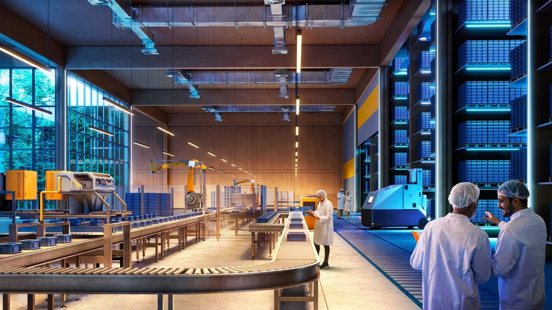 Inside a high-tech warehouse or manufacturing plant, several workers in lab coats and hairnets are working among conveyor belts, robotic arms, and shelves filled with boxes. The space is illuminated with bright lighting, and large windows reveal trees outside.