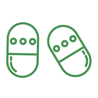 Two green capsules with a line and circular markings on each.