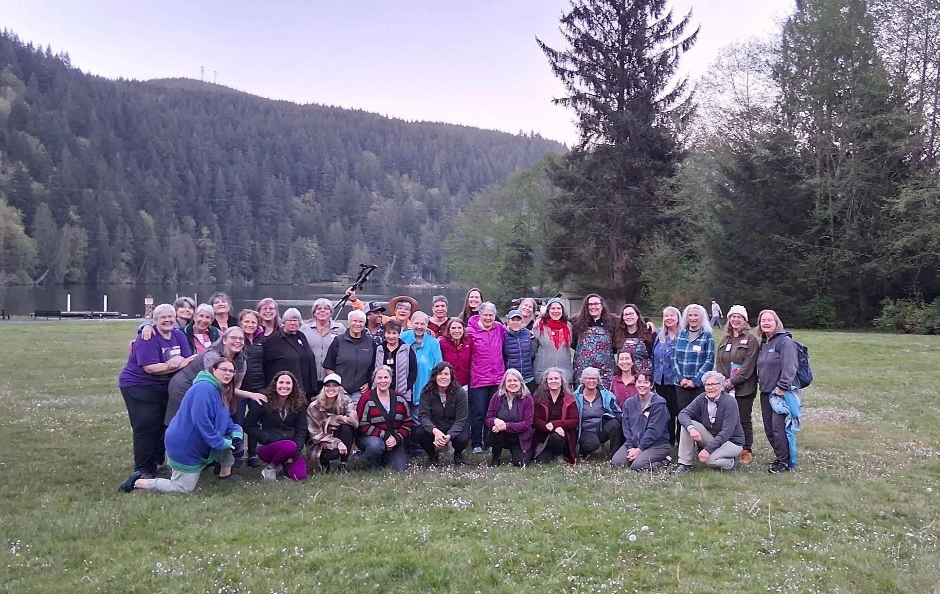 Group of 50 women pose by Lake Samish at the 2025 BUF women's retreat