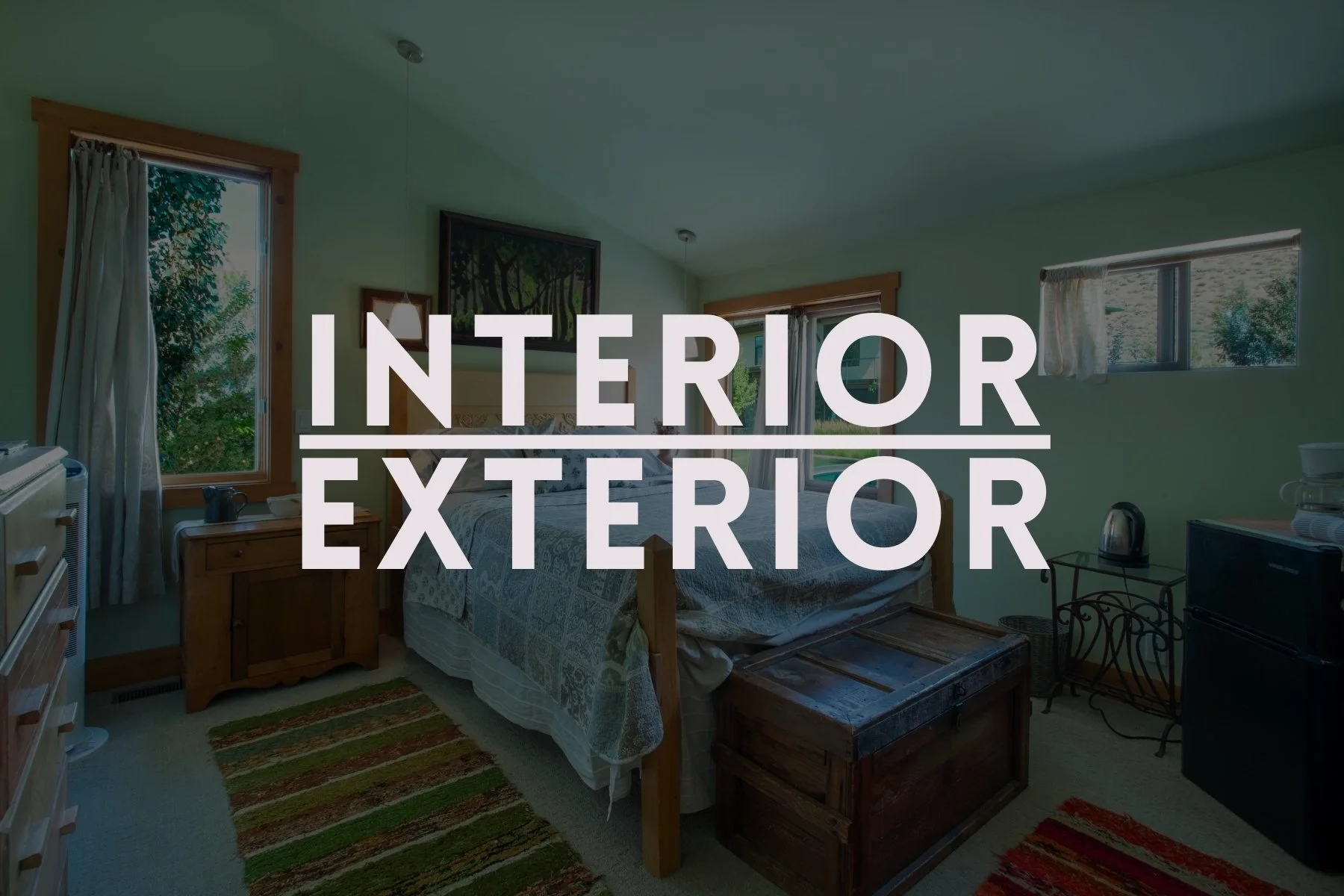 A bedroom with a bed, three windows showing outside greenery, a wooden nightstand, a rug, a dresser, and a small fridge, with the words 'Interior' and 'Exterior' overlapping.