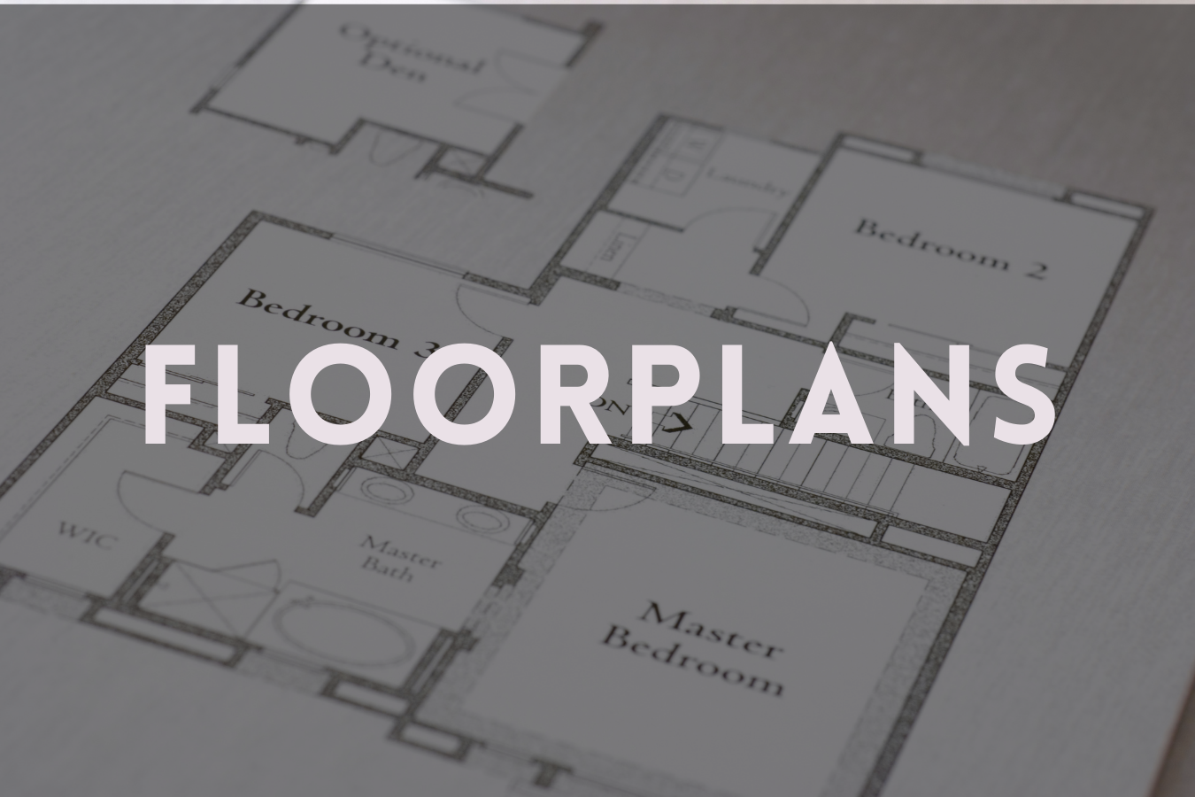 A floor plan blueprint showing multiple bedrooms and bathrooms for a house.