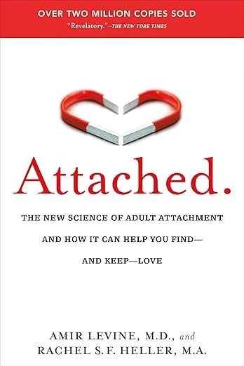 Book cover titled 'Attached' with a red heart-shaped magnet at the top.